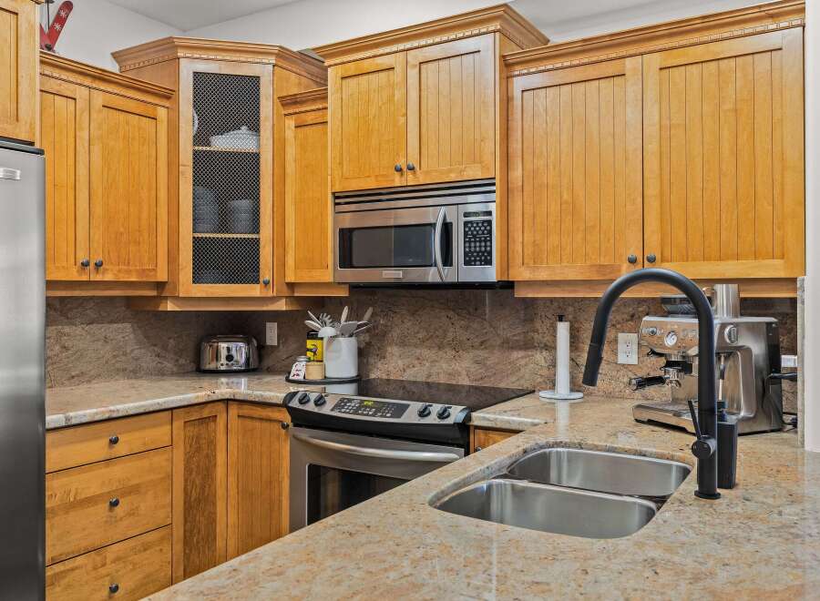 This stunning kitchen boasts beautiful wooden cabinetry and sleek stainless steel appliances.