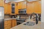 This stunning kitchen boasts beautiful wooden cabinetry and sleek stainless steel appliances.