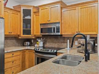This stunning kitchen boasts beautiful wooden cabinetry and sleek stainless steel appliances.