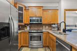 This stunning kitchen boasts beautiful wooden cabinetry, stainless steel appliances, and a sleek granite countertop.