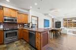 This stunning kitchen boasts custom cabinetry, stainless steel appliances, and a beautiful stone countertop.