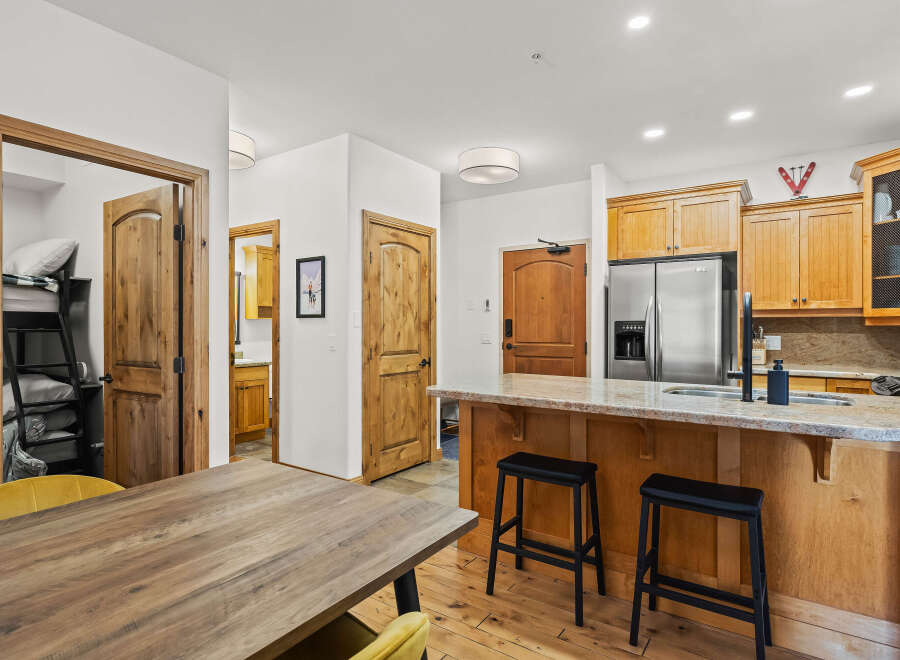 Step into this beautifully designed kitchen, featuring warm wooden cabinetry and a sleek stainless steel refrigerator.