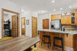 Step into this beautifully designed kitchen, featuring warm wooden cabinetry and a sleek stainless steel refrigerator.
