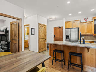 Step into this beautifully designed kitchen, featuring warm wooden cabinetry and a sleek stainless steel refrigerator.