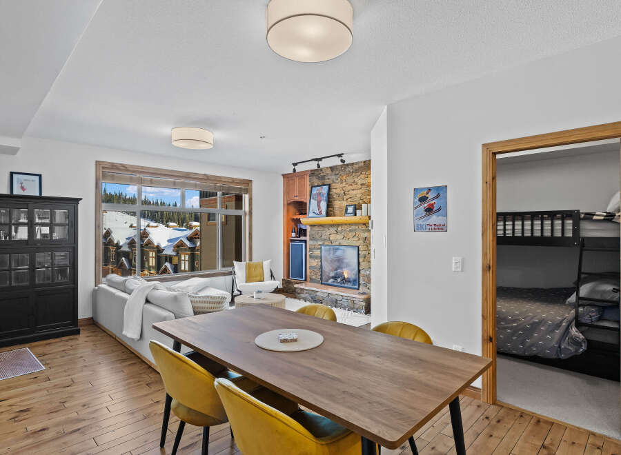 Experience luxury living in this stunning property, featuring a cozy fireplace and a modern dining area.