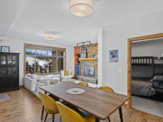 Experience luxury living in this stunning property, featuring a cozy fireplace and a modern dining area.