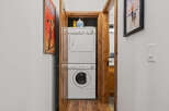 Discover the convenience of this home's dedicated laundry area, featuring a stacked washer and dryer for efficient use of space.