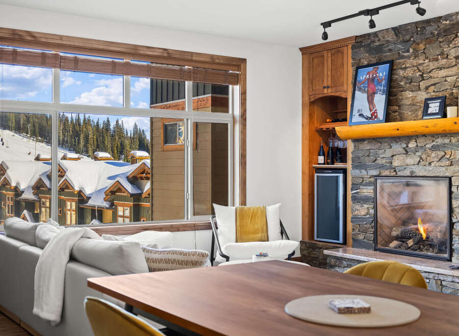 Experience luxury living in this stunning property featuring a cozy fireplace and a modern wine cooler.