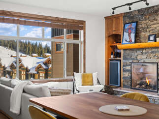 Experience luxury living in this stunning property featuring a cozy fireplace and a modern wine cooler.