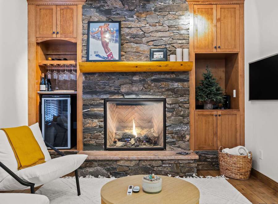 Cozy up in front of the fireplace in this stunning property! This home features a beautiful stone fireplace, perfect for those chilly evenings.