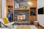 Cozy up in front of the fireplace in this stunning property! This home features a beautiful stone fireplace, perfect for those chilly evenings.