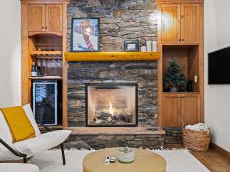 Cozy up in front of the fireplace in this stunning property! This home features a beautiful stone fireplace, perfect for those chilly evenings.
