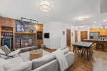 Experience the warmth of this stunning living space, featuring a cozy fireplace and elegant wooden cabinetry.