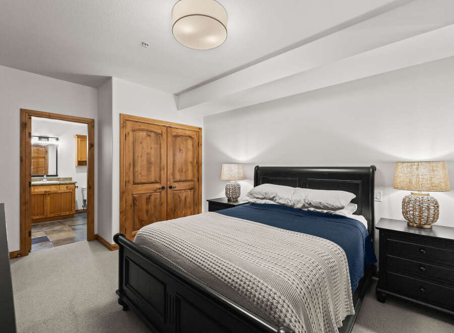 Step into this inviting bedroom, featuring a cozy bed adorned with plush bedding and a stylish throw.