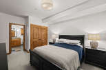 Step into this inviting bedroom, featuring a cozy bed adorned with plush bedding and a stylish throw.