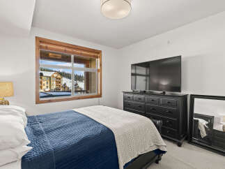 This cozy bedroom offers a serene retreat with stunning views.