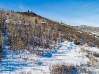 Nestled in a serene mountain landscape, this property offers a unique blend of natural beauty and modern living.