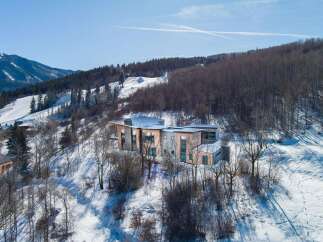 This stunning modern home is nestled in a picturesque mountain setting, offering breathtaking views and unparalleled privacy.