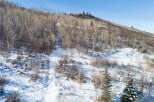Nestled in a serene winter landscape, this property offers a unique blend of natural beauty and modern living.