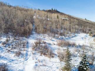 Nestled in a serene winter landscape, this property offers a unique blend of natural beauty and modern living.