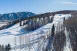 Enjoy breathtaking mountain views and pristine slopes in this stunning winter wonderland.