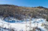 Nestled in a serene winter landscape, this property offers a unique blend of natural beauty and architectural design.