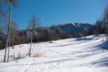Explore the serene beauty of this winter wonderland! This stunning property boasts a picturesque landscape with snow-covered terrain and majestic mountains in the background.