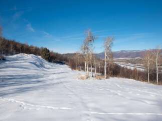Explore this stunning winter landscape, perfect for building your dream home.
