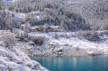 Nestled in a serene winter wonderland, this property offers breathtaking views of a snow-covered landscape and a tranquil lake.