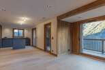 Experience luxury living in this stunning property featuring a modern kitchen with sleek cabinetry and an island.