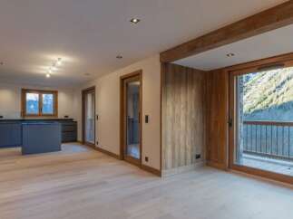Experience luxury living in this stunning property featuring a modern kitchen with sleek cabinetry and an island.