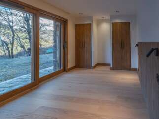 This stunning property boasts a bright and airy interior with beautiful wooden floors and large windows that offer breathtaking views of the surrounding landscape.
