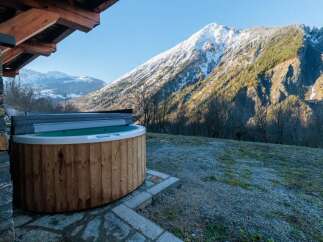 Enjoy breathtaking mountain views from this luxurious property featuring a private hot tub.