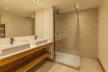 This stunning bathroom features a modern design with a spacious walk-in shower and a double vanity.