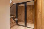 Step into luxury with this stunning property featuring a modern glass door entrance.