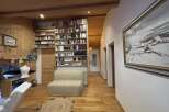 Step into this charming home with a cozy living space featuring a built-in bookcase and a comfortable sofa.