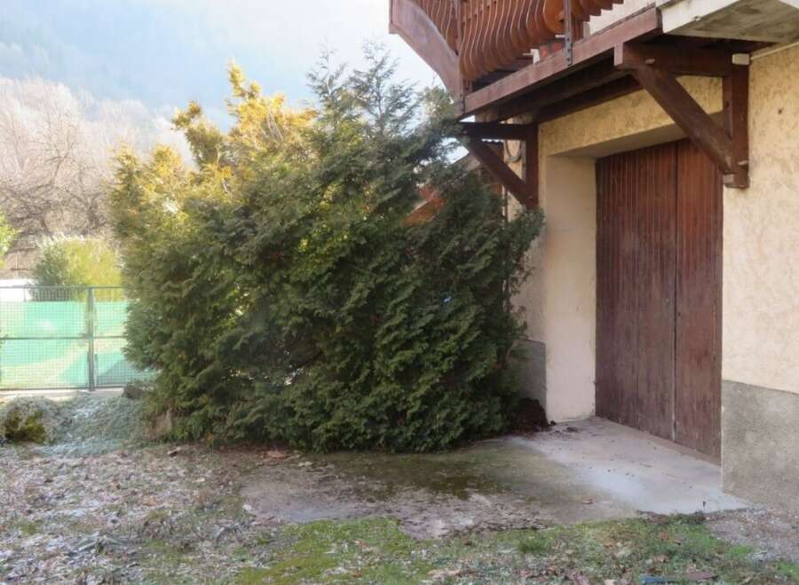 Discover this charming property featuring a beautiful wooden balcony and a rustic wooden door.