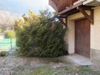 Discover this charming property featuring a beautiful wooden balcony and a rustic wooden door.