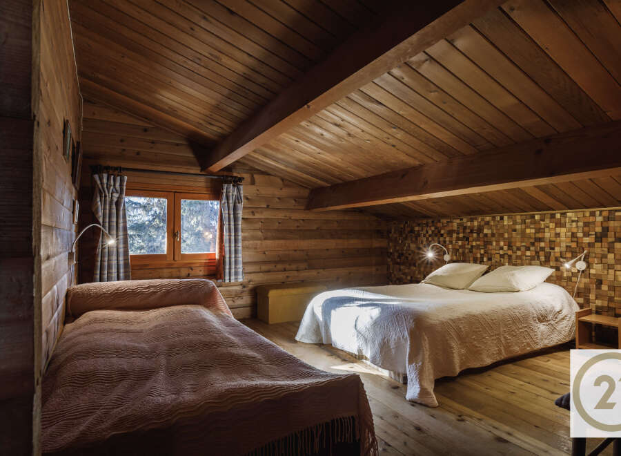 This cozy bedroom features a rustic wooden interior, creating a warm and inviting atmosphere.