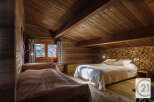 This cozy bedroom features a rustic wooden interior, creating a warm and inviting atmosphere.