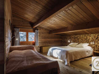 This cozy bedroom features a rustic wooden interior, creating a warm and inviting atmosphere.
