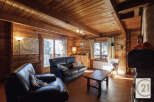This cozy cabin boasts a warm and inviting atmosphere with its wooden interior and charming details.