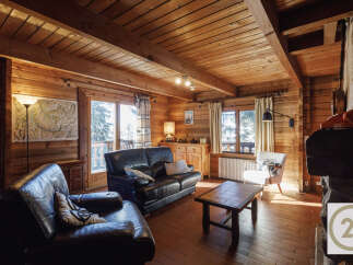 This cozy cabin boasts a warm and inviting atmosphere with its wooden interior and charming details.
