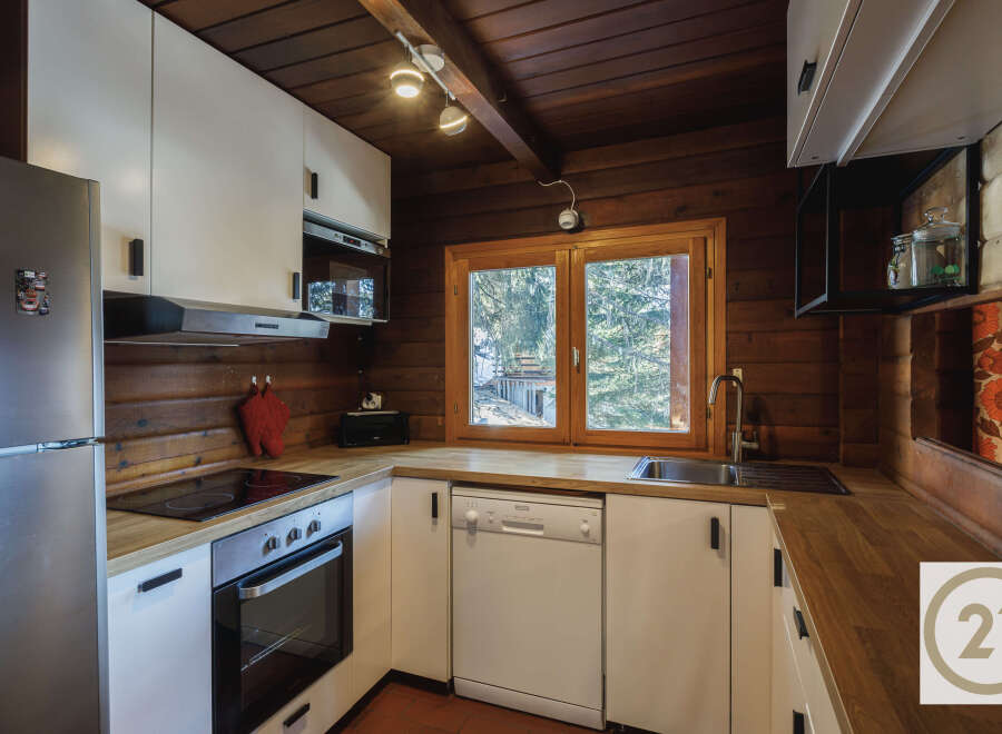 This charming kitchen boasts a rustic, inviting atmosphere with its wooden accents and modern appliances.