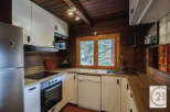 This charming kitchen boasts a rustic, inviting atmosphere with its wooden accents and modern appliances.