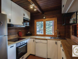 This charming kitchen boasts a rustic, inviting atmosphere with its wooden accents and modern appliances.