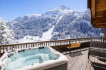 Enjoy breathtaking mountain views from this luxurious chalet featuring a private hot tub.