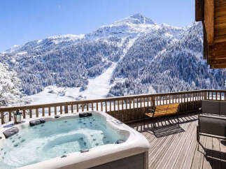 Enjoy breathtaking mountain views from this luxurious chalet featuring a private hot tub.