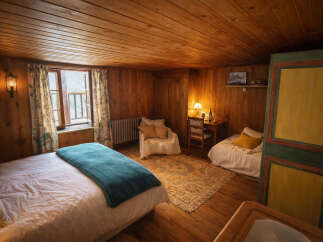 Step into a cozy retreat with this charming bedroom, featuring warm wooden walls and ceilings that create a rustic ambiance.