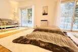 This cozy living space features a traditional kotatsu table, perfect for relaxing and enjoying the warmth.